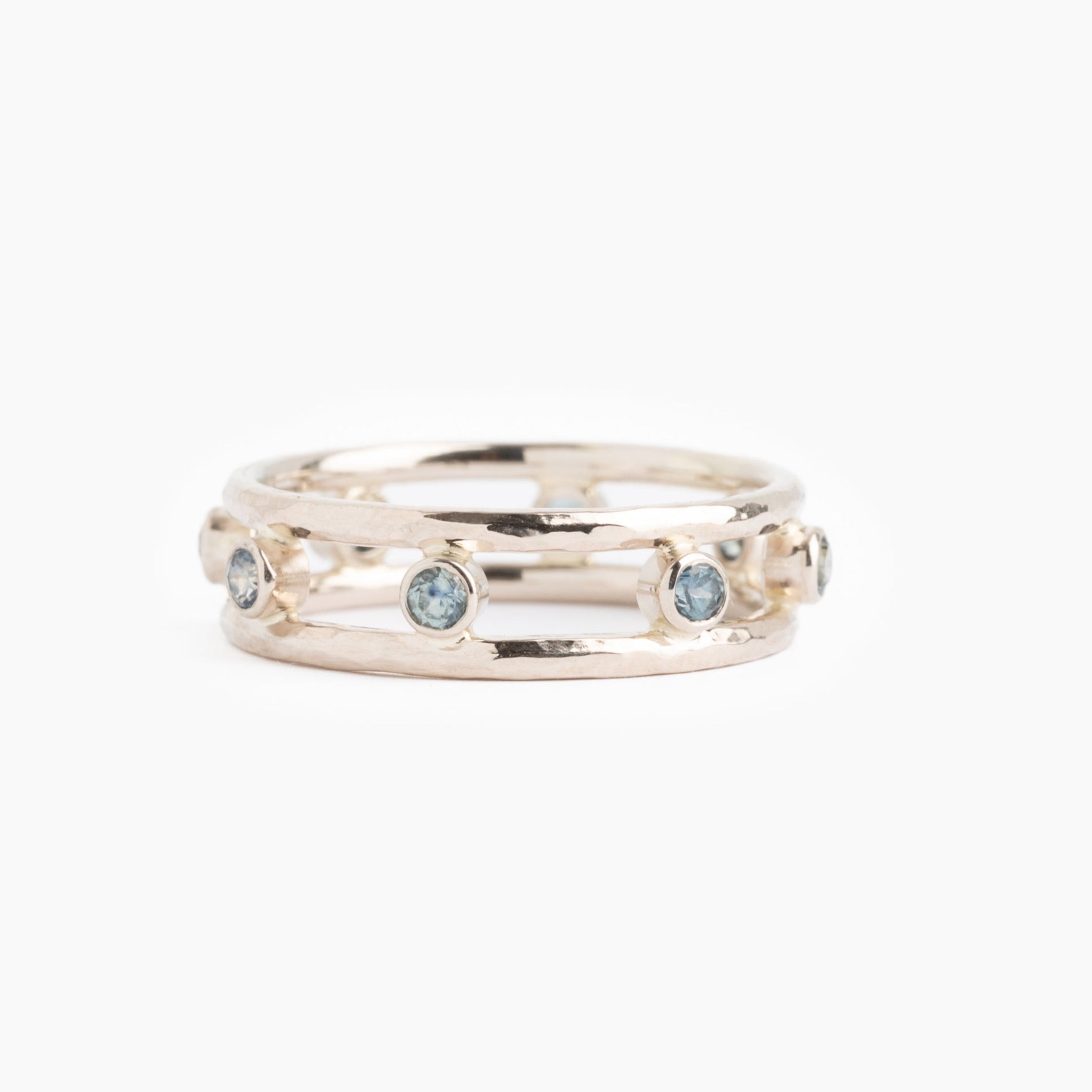 Gold ring with embedded stones on a white background
