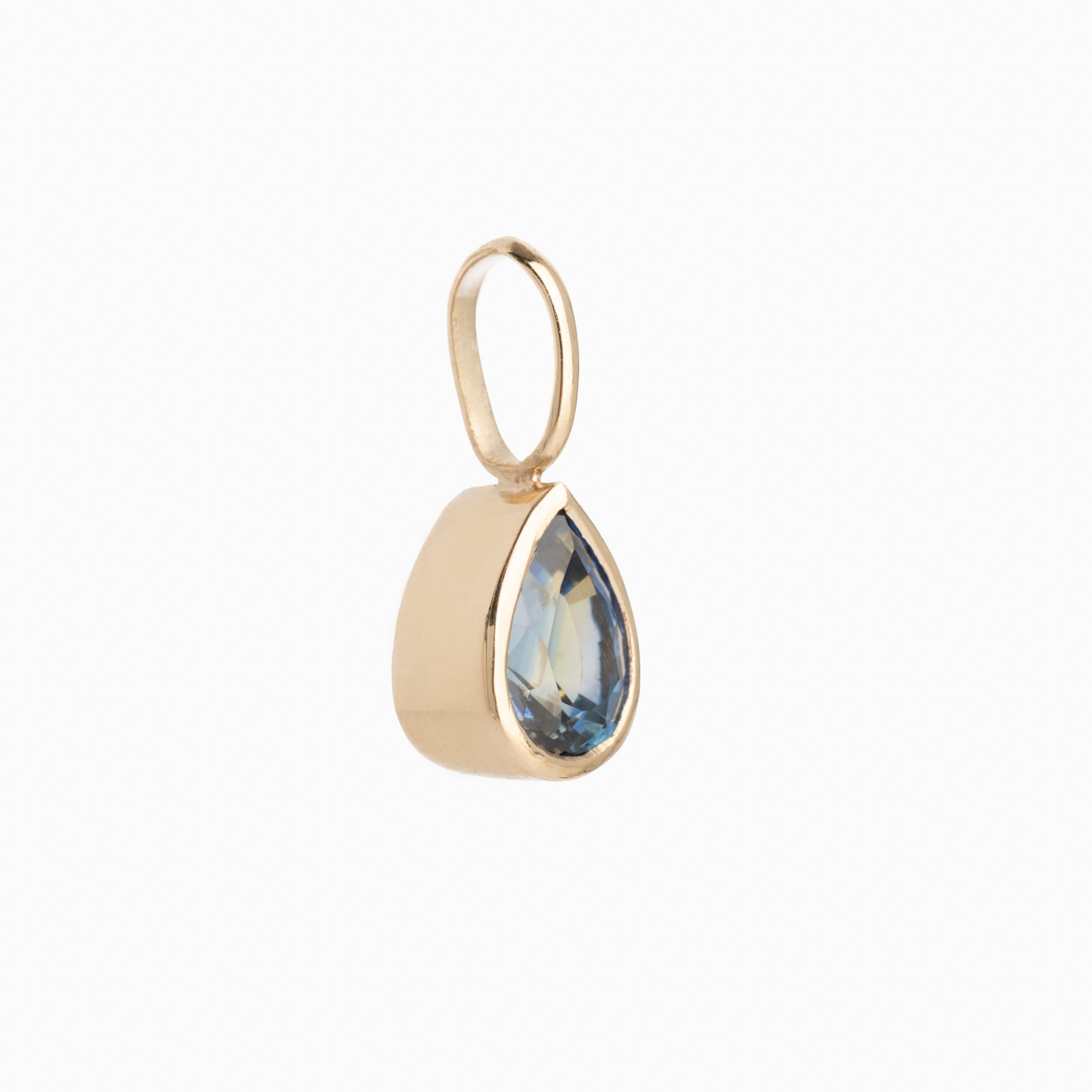 Gold pendant with a teardrop-shaped blue gemstone on a white background