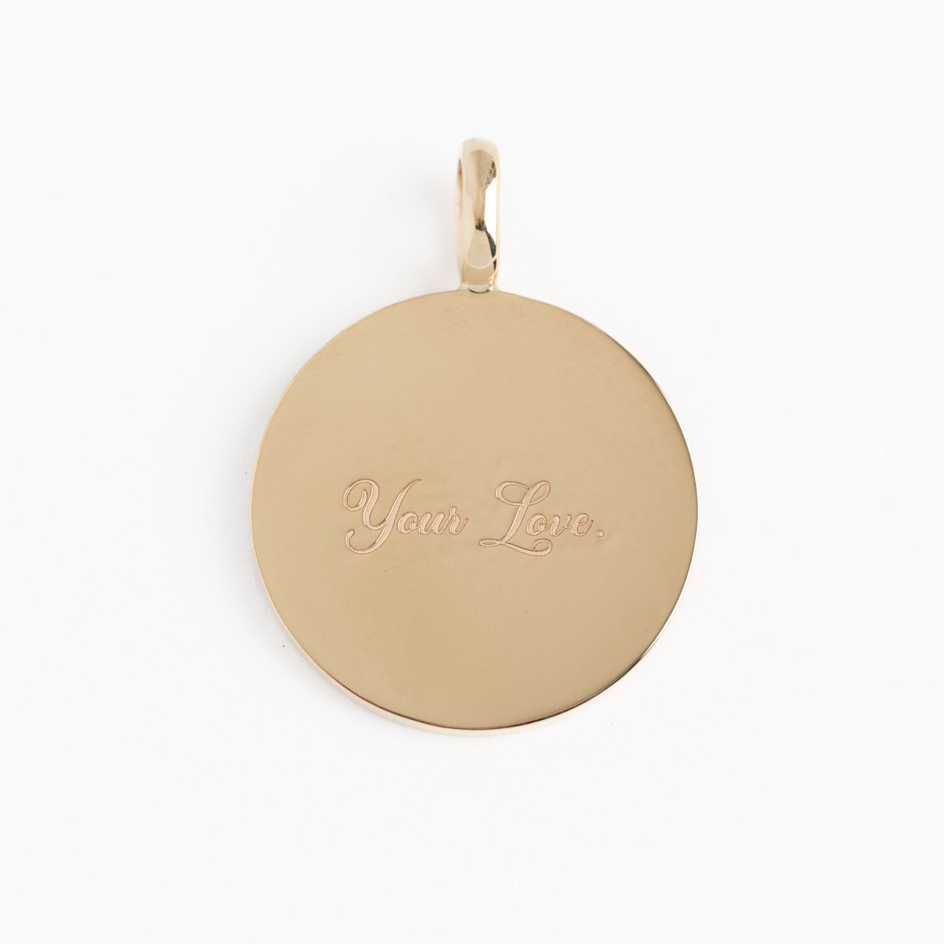 Gold pendant with 'Your Love' engraving on a white background