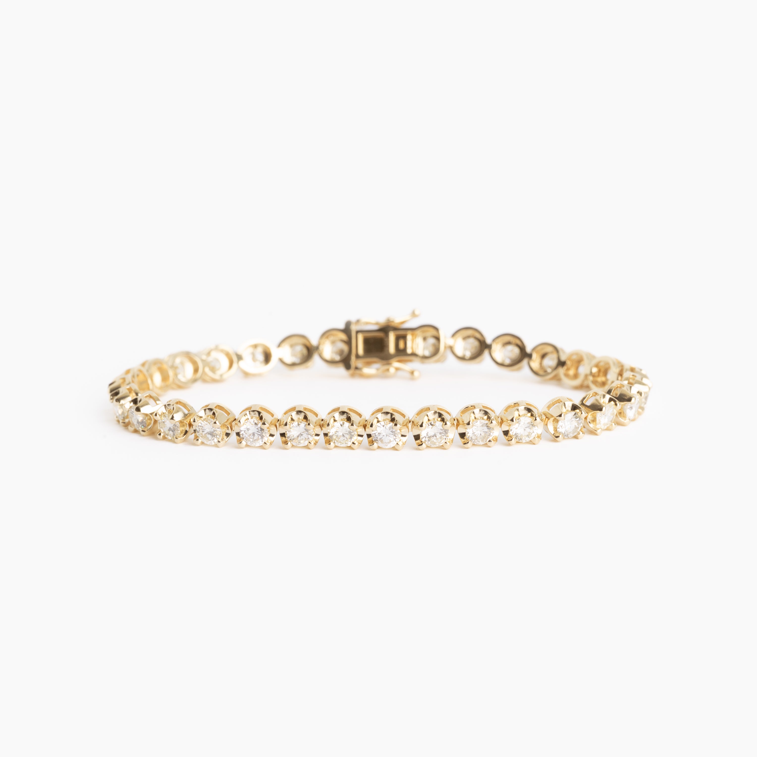 Gold bracelet with diamonds on a white background