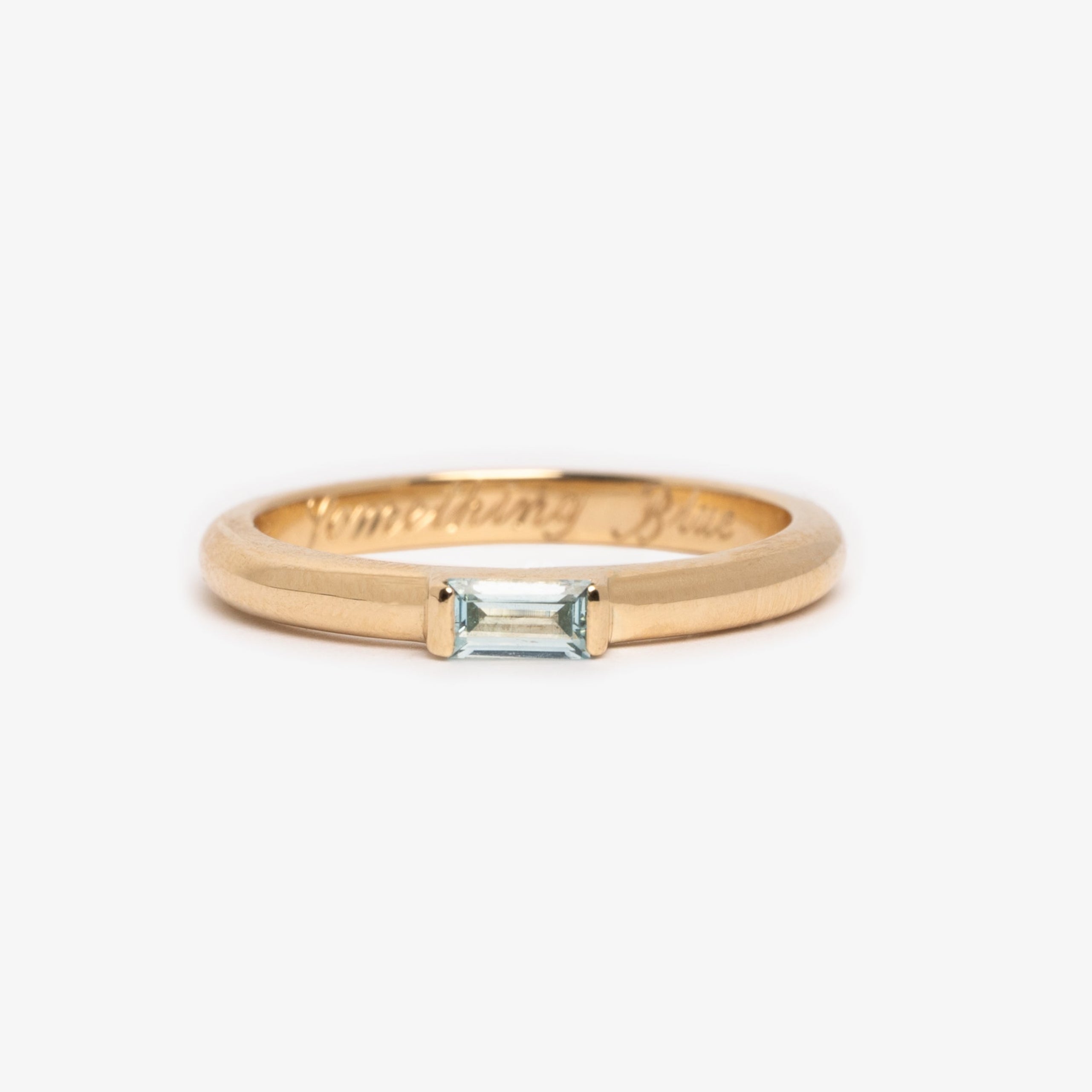 Gold ring with a aqua marine on a white background