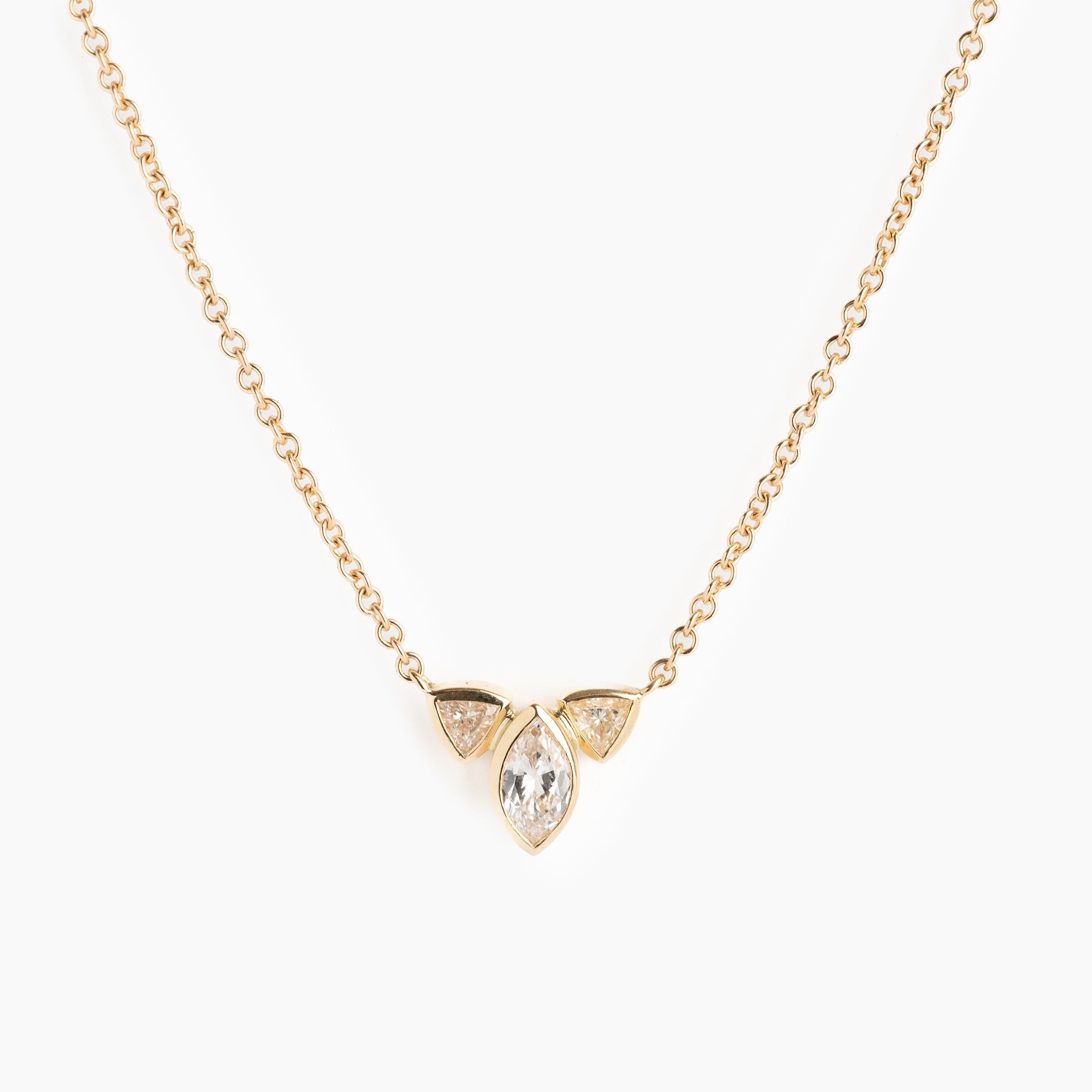 Gold necklace with a teardrop-shaped pendant on a white background
